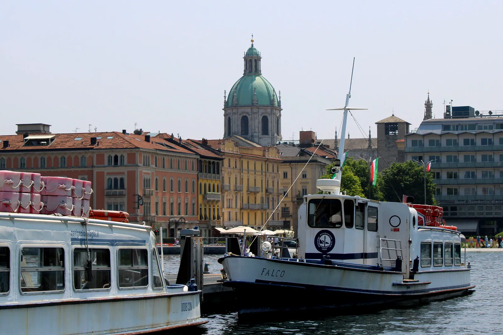 The Duomo of Como behind the lake boats at the pier.