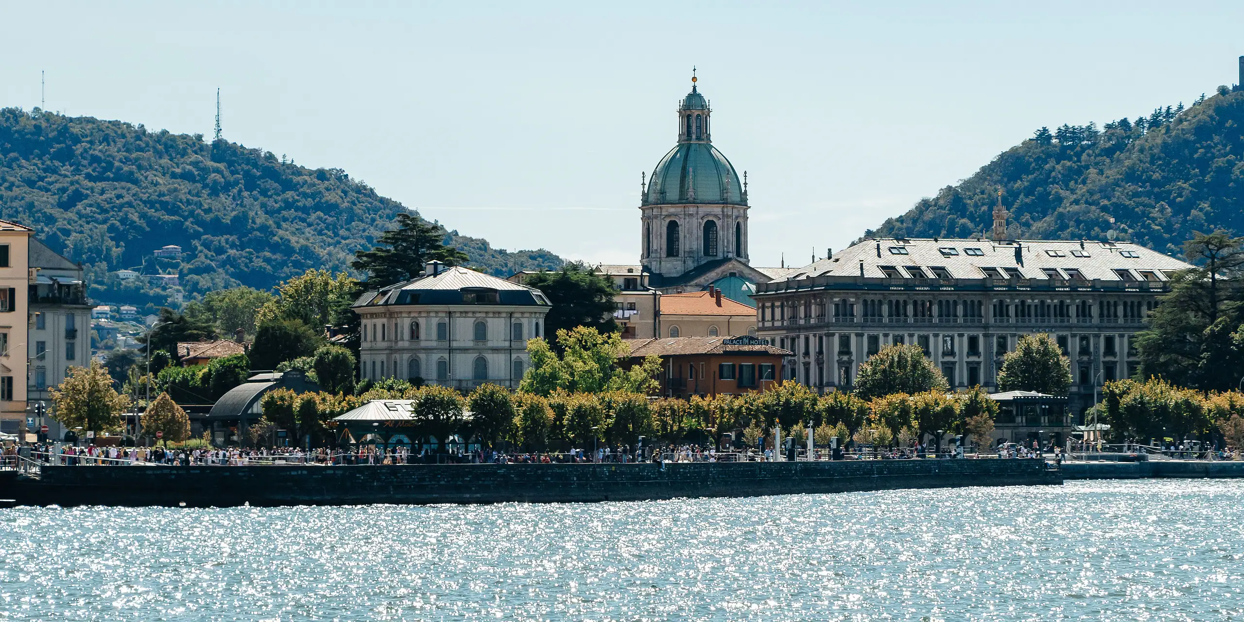 The Duomo of Como above the lakefront, by day.