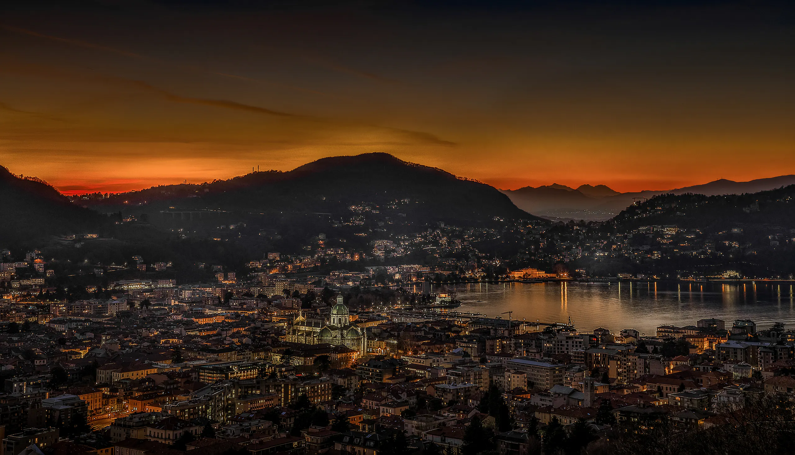 Como after sunset. The cathedral dome, the city lights and the lake.